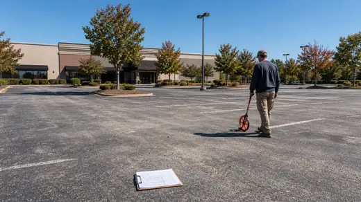 Commercial parking field surveyed for a written concrete estimate in Savannah, GA, in clear late-morning sun.